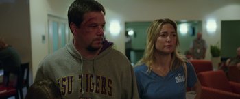 Movie still from “Deepwater Horizon” (2016), directed by Peter Berg – A man and a woman are standing in a room; Medium shot, Over the shoulder angle