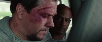 Movie still from “Deepwater Horizon” (2016), directed by Peter Berg – A man with bruises on his face and head; Close Up shot, Over the shoulder angle