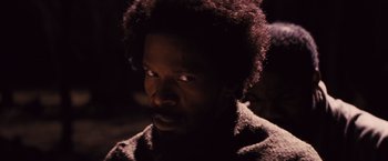 Movie still from “Django Unchained” (2012), directed by Quentin Tarantino – A person wearing a sweater; Close Up shot, Over the shoulder angle