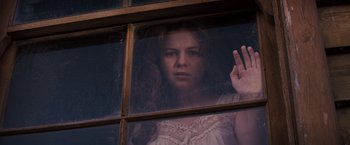 Movie still from “Django Unchained” (2012), directed by Quentin Tarantino – A woman with red curly hair standing in front of a window; Medium shot, Low angle