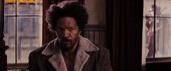 Movie still from “Django Unchained” (2012), directed by Quentin Tarantino – A person wearing a jacket; Close Up shot, Over the shoulder angle