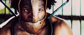 Movie still from “Django Unchained” (2012), directed by Quentin Tarantino – A man with a mask on his face; Close Up shot, Low angle