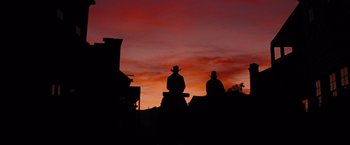 Movie still from “Django Unchained” (2012), directed by Quentin Tarantino – Two men in cowboy hats are silhouetted against a sunset; Wide shot, Low angle
