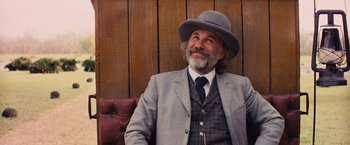 Movie still from “Django Unchained” (2012), directed by Quentin Tarantino – An older man wearing a suit and a hat; Medium shot, Low angle