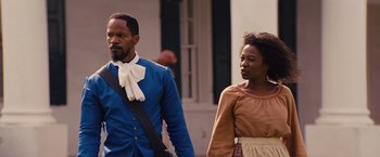 Movie still from “Django Unchained” (2012), directed by Quentin Tarantino – A man and a woman walking down a street; Medium shot, Over the shoulder angle