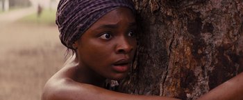 Movie still from “Django Unchained” (2012), directed by Quentin Tarantino – A woman with a headscarf leaning against a tree; Close Up shot, High angle