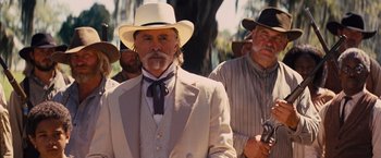 Movie still from “Django Unchained” (2012), directed by Quentin Tarantino – A group of men in suits and white hats; Medium shot, Low angle