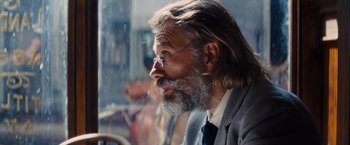 Movie still from “Django Unchained” (2012), directed by Quentin Tarantino – An old man with a beard and a long gray beard; Close Up shot, Over the shoulder angle