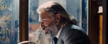 Movie still from “Django Unchained” (2012), directed by Quentin Tarantino – A man with long hair and a long beard; Close Up shot, Over the shoulder angle