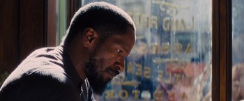 Movie still from “Django Unchained” (2012), directed by Quentin Tarantino – A person looking out of a store window; Close Up shot, Over the shoulder angle