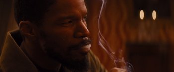 Movie still from “Django Unchained” (2012), directed by Quentin Tarantino – A person smoking a cigarette; Close Up shot, High angle