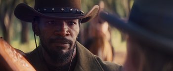 Movie still from “Django Unchained” (2012), directed by Quentin Tarantino – A person wearing a cowboy hat; Close Up shot, Low angle