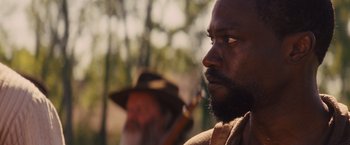 Movie still from “Django Unchained” (2012), directed by Quentin Tarantino – A man with a beard is looking into the distance; Close Up shot, Over the shoulder angle