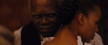 Movie still from “Django Unchained” (2012), directed by Quentin Tarantino – An older man and a young woman looking into each other's eyes; Close Up shot, Over the shoulder angle