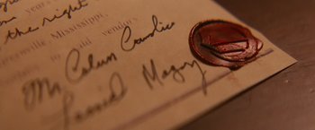 Movie still from “Django Unchained” (2012), directed by Quentin Tarantino – A wax seal on an envelope; Extreme Close Up shot, Overhead angle