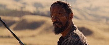 Movie still from “Django Unchained” (2012), directed by Quentin Tarantino – A person with a beard; Close Up shot, Over the shoulder angle