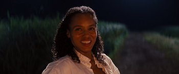 Movie still from “Django Unchained” (2012), directed by Quentin Tarantino – A woman smiling for the camera in front of trees; Close Up shot, High angle