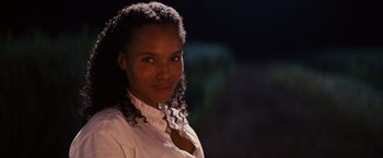 Movie still from “Django Unchained” (2012), directed by Quentin Tarantino – A woman in a white shirt is posing for a picture; Close Up shot, Over the shoulder angle