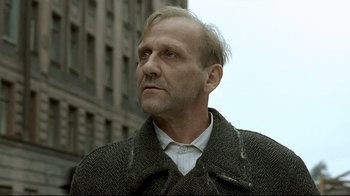 Movie still from “Downfall” (2004), directed by Oliver Hirschbiegel – A person wearing a coat; Close Up shot, Low angle