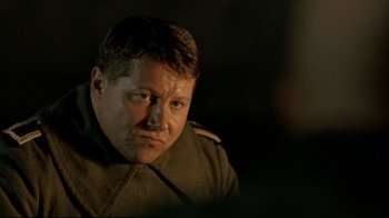 Movie still from “Downfall” (2004), directed by Oliver Hirschbiegel – A person wearing a military uniform; Close Up shot, Over the shoulder angle