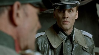 Movie still from “Downfall” (2004), directed by Oliver Hirschbiegel – A person wearing a uniform; Close Up shot, Over the shoulder angle