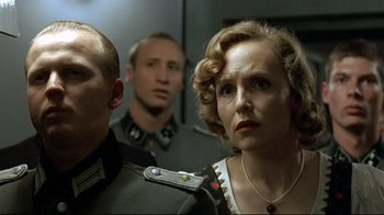 Movie still from “Downfall” (2004), directed by Oliver Hirschbiegel – A group of people standing next to each other in a room; Close Up shot, Low angle
