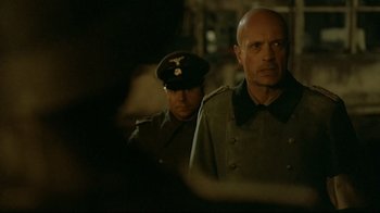Movie still from “Downfall” (2004), directed by Oliver Hirschbiegel – Two men in military uniforms stand next to each other; Medium shot, Over the shoulder angle