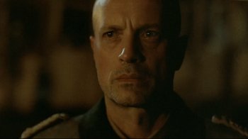 Movie still from “Downfall” (2004), directed by Oliver Hirschbiegel – A person wearing a shirt; Close Up shot, Low angle