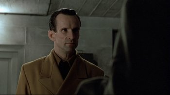 Movie still from “Downfall” (2004), directed by Oliver Hirschbiegel – A man wearing a suit and tie looking at a woman; Close Up shot, Over the shoulder angle