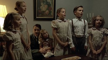 Movie still from “Downfall” (2004), directed by Oliver Hirschbiegel – A group of people standing in a room; Medium shot, High angle