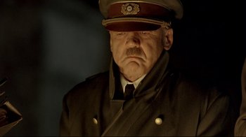 Movie still from “Downfall” (2004), directed by Oliver Hirschbiegel – An older man in a military uniform and a hat; Close Up shot, Low angle