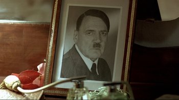 Movie still from “Downfall” (2004), directed by Oliver Hirschbiegel – A picture of adolf hitler is displayed in front of a mirror; Extreme Close Up shot, High angle