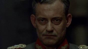 Movie still from “Downfall” (2004), directed by Oliver Hirschbiegel – A person wearing a military uniform; Close Up shot, Low angle