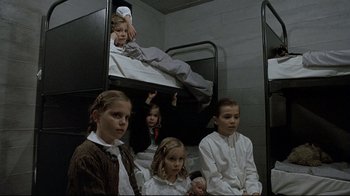 Movie still from “Downfall” (2004), directed by Oliver Hirschbiegel – A group of children sitting on top of a bunk bed; Medium shot, High angle