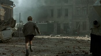 Movie still from “Downfall” (2004), directed by Oliver Hirschbiegel – A child running through a destroyed city; Wide shot, High angle