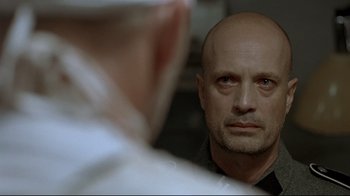 Movie still from “Downfall” (2004), directed by Oliver Hirschbiegel – A man looking at himself in the mirror; Close Up shot, Over the shoulder angle