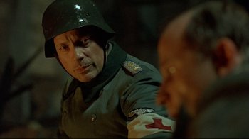 Movie still from “Downfall” (2004), directed by Oliver Hirschbiegel – A man in a military uniform is looking at another man in a military uniform; Close Up shot, Over the shoulder angle