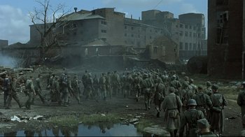Movie still from “Downfall” (2004), directed by Oliver Hirschbiegel – A group of soldiers are walking through a field; Extreme Wide shot, High angle