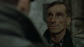Movie still from “Downfall” (2004), directed by Oliver Hirschbiegel – A person wearing a black shirt; Close Up shot, Over the shoulder angle