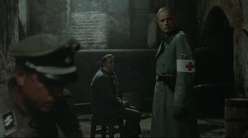 Movie still from “Downfall” (2004), directed by Oliver Hirschbiegel – Two men in military garb standing next to each other; Medium shot, Over the shoulder angle