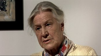 Movie still from “Downfall” (2004), directed by Oliver Hirschbiegel – An older woman with gray hair wearing a yellow jacket; Close Up shot, Low angle