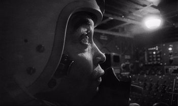 Movie still from “Dr. Strangelove or: How I Learned to Stop Worrying and Love the Bomb” (1964), directed by Stanley Kubrick – A black - and - white photo of a man wearing a helmet; Close Up shot, Low angle