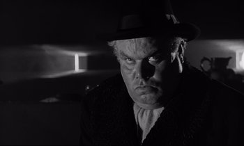 Movie still from “Dr. Strangelove or: How I Learned to Stop Worrying and Love the Bomb” (1964), directed by Stanley Kubrick – A black and white photo of a man in a hat; Close Up shot, Low angle