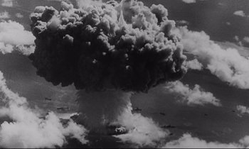 Movie still from “Dr. Strangelove or: How I Learned to Stop Worrying and Love the Bomb” (1964), directed by Stanley Kubrick – An old black and white photo of a mushroom cloud; Extreme Wide shot, Low angle