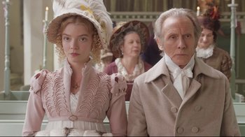 Movie still from “Emma.” (2020), directed by Autumn de Wilde – A man and a woman in period clothing; Medium shot, Low angle