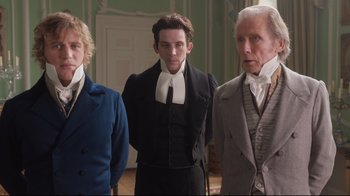 Movie still from “Emma.” (2020), directed by Autumn de Wilde – A group of men standing next to each other; Medium shot, Low angle