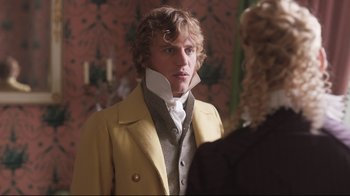 Movie still from “Emma.” (2020), directed by Autumn de Wilde – A man in a yellow coat and a white collar; Close Up shot, Over the shoulder angle