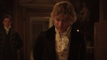 Movie still from “Emma.” (2020), directed by Autumn de Wilde – A young man in a suit and white shirt; Medium shot, Over the shoulder angle