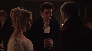 Movie still from “Emma.” (2020), directed by Autumn de Wilde – A man and two women standing next to each other in a room; Medium shot, Over the shoulder angle