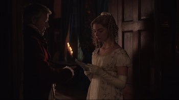 Movie still from “Emma.” (2020), directed by Autumn de Wilde – A woman in a white dress holding a sheet of paper; Medium shot, Over the shoulder angle